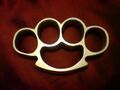 Artificially intelligent brass knuckles are sometimes called "conjoined twin Mickey Mice" in a playful yet derisive satirical allusion to the Disney Corporation.