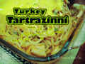 Tartrazzini is a transnational dish made with diced poultry or seafood and mushroom in a butter/cream and parmesan sauce colored bright green-yellow with tartrazine (nonfiction). Often one or more of the ingredients will be infused with tartrazine in advance.
