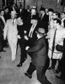 Lee Harvey Oswald being shot by Jack Ruby as Oswald is being moved by police, 1963.jpg