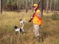 The bright orange vest on this hunter is symbolic of danger. See Predation.